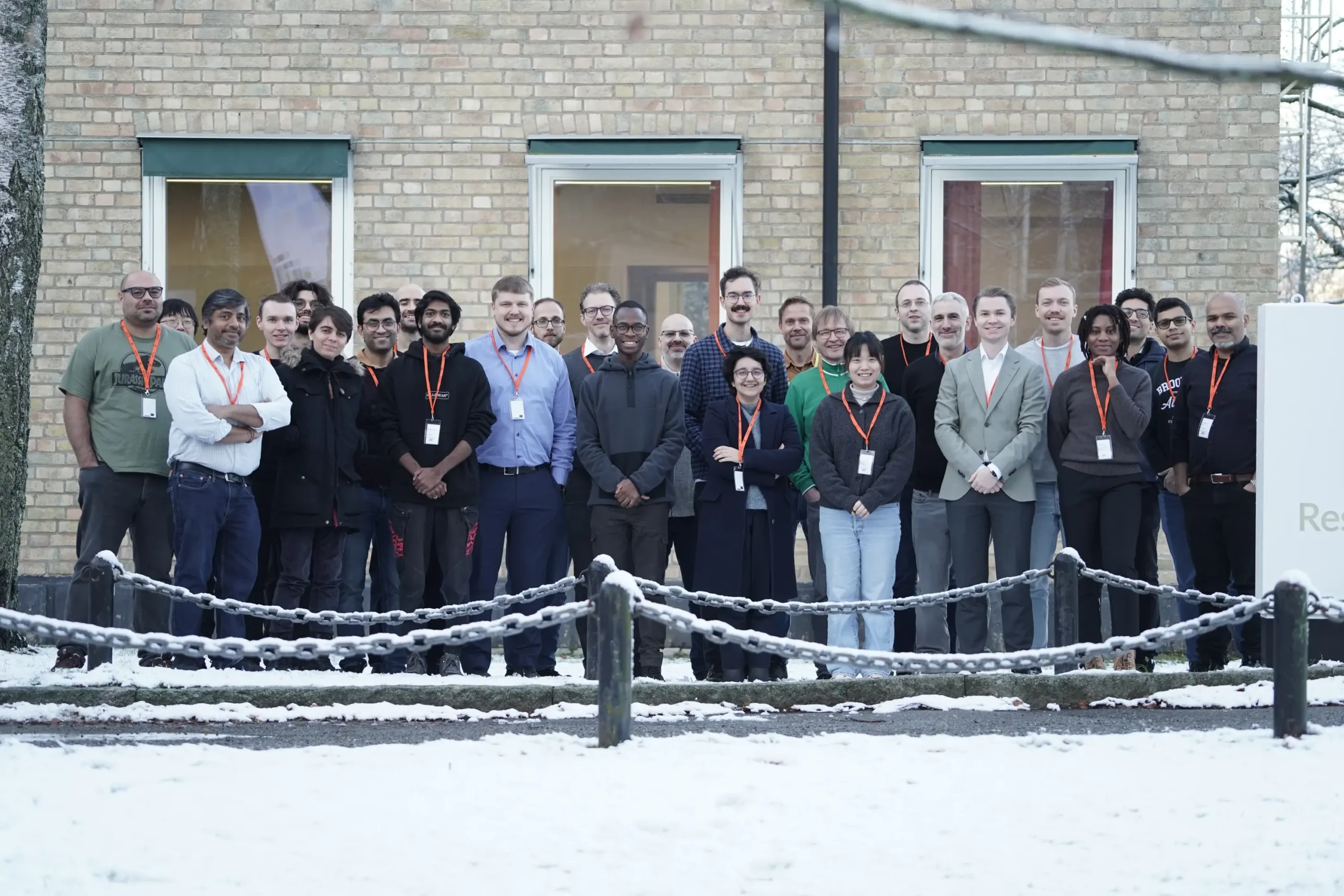 A outdoor group photo of the participants of the Quantum Autumn School 2024 in Stockholm. Snowy environment.