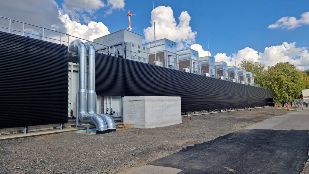 An industrial building that houses JUPITER supercomputer. The building is very large with ventilations securing the transfer of heat from the superocomputer.